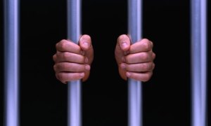Hand On Prison Bars